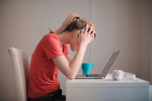 stressed woman looking at a laptop