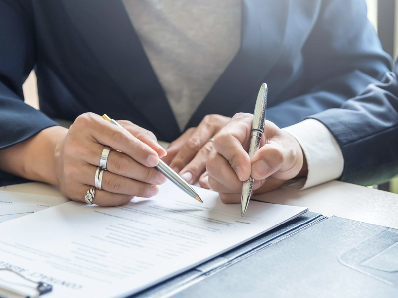 A group of business people sign a joint investment contract
