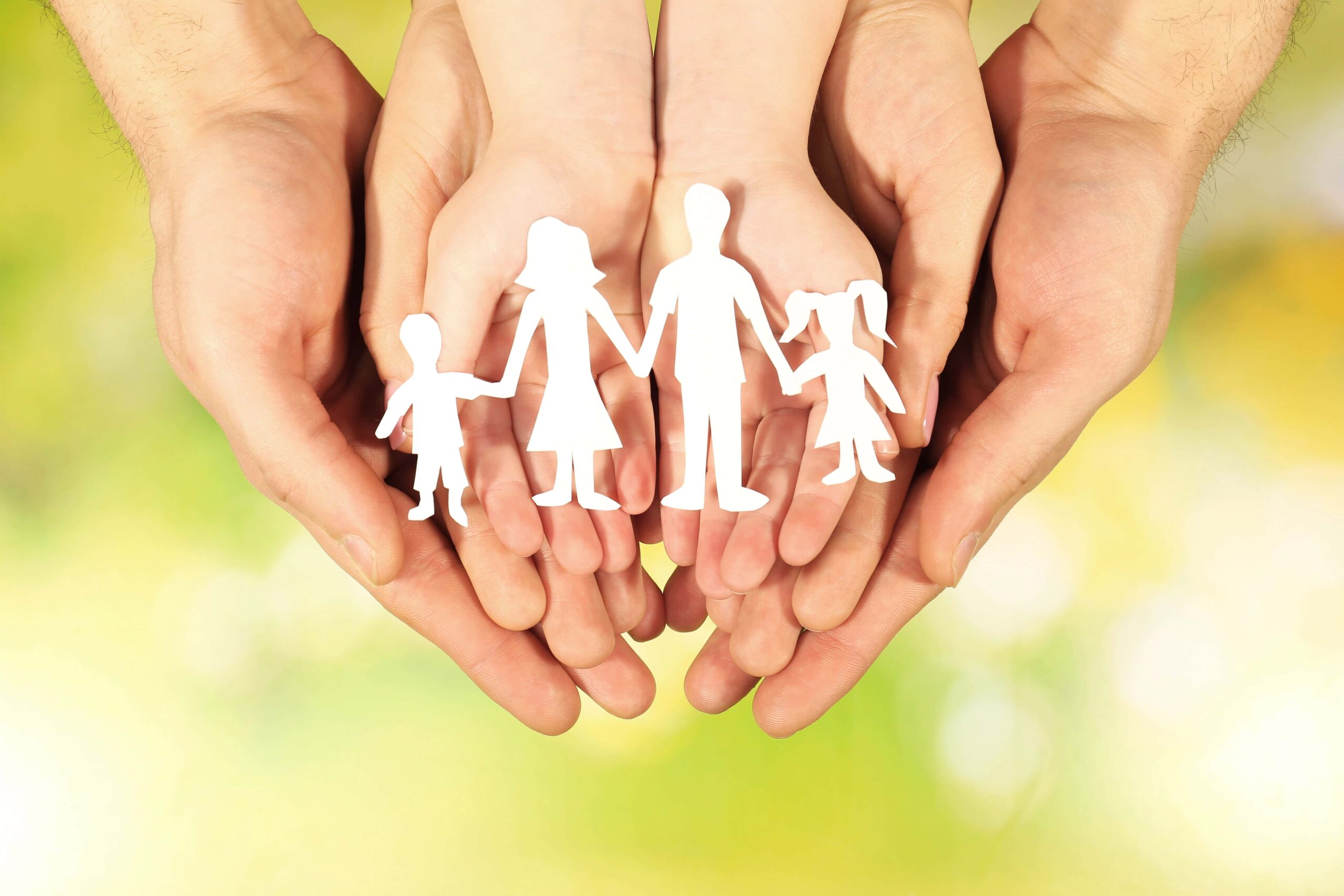 hands holding paper cutout family 1 scaled