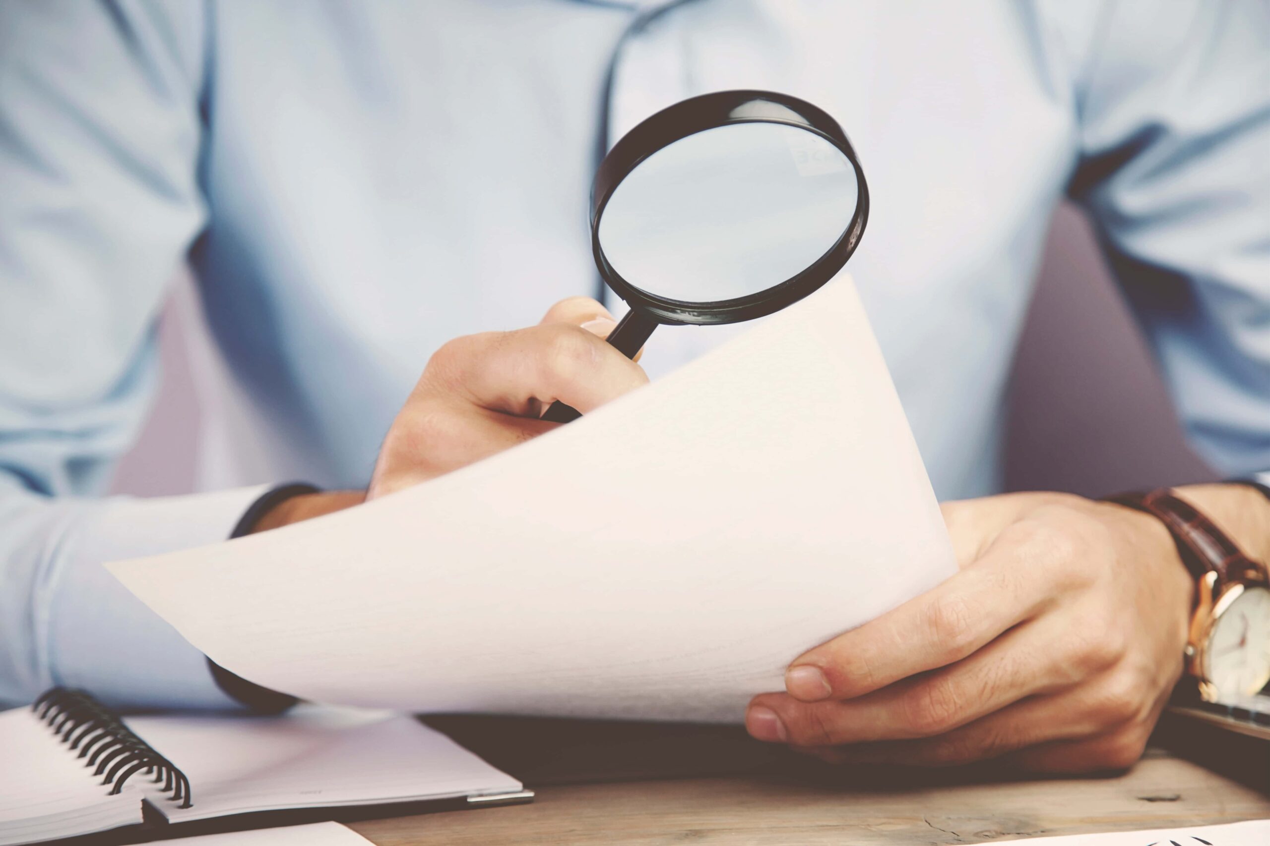 man hand magnifying scaled