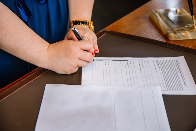 woman signing legal document