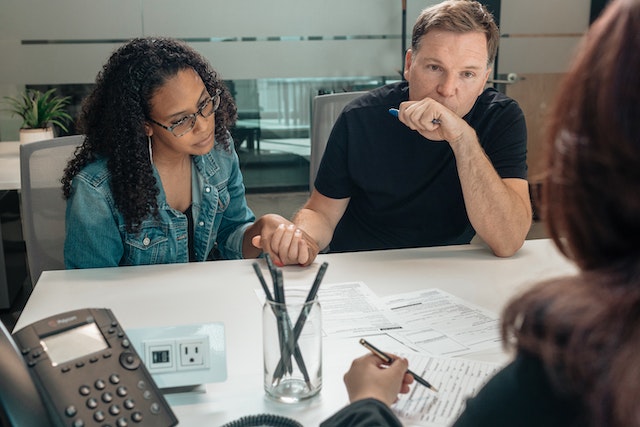 couple holding hands during meeting