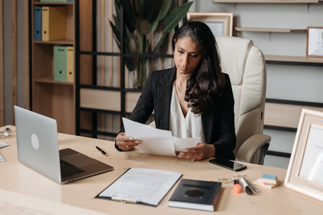 woman looking at documents on desk