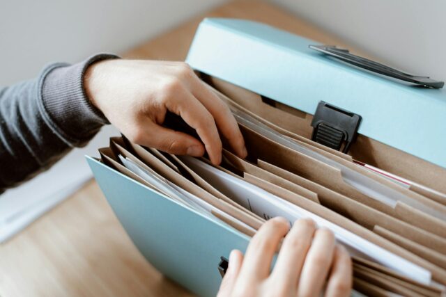 woman looking through file folder